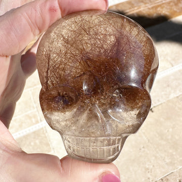 Rutile Quartz Palm Crystal Skull Carved by Leandro de Souza