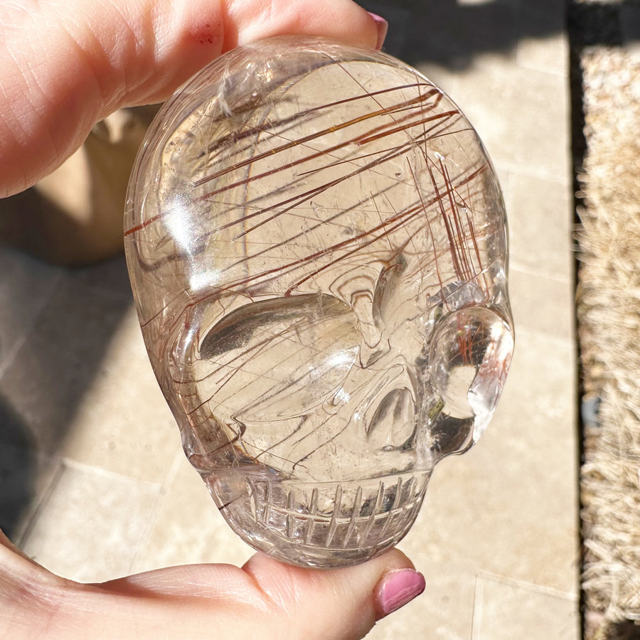 Ultra Clear Rutile Quartz Palm Crystal Skull Carved by Leandro de Souza