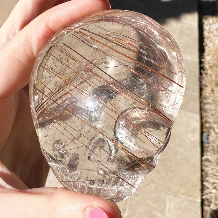 Ultra Clear Rutile Quartz Palm Crystal Skull Carved by Leandro de Souza