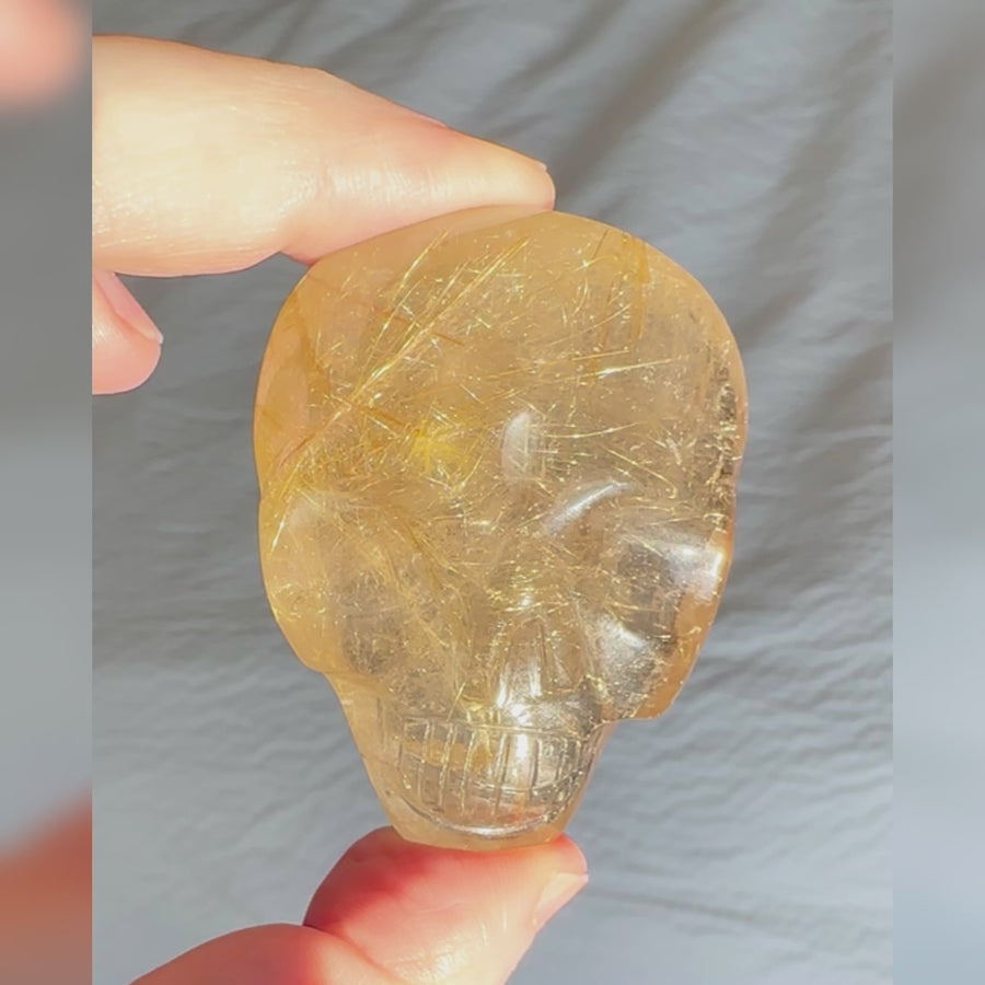 Rutile Quartz Palm Crystal Skull Carved by Leandro de Souza
