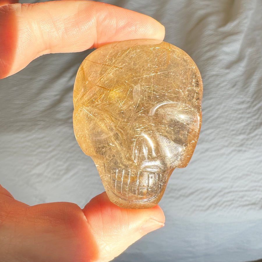 Rutile Quartz Palm Crystal Skull Carved by Leandro de Souza