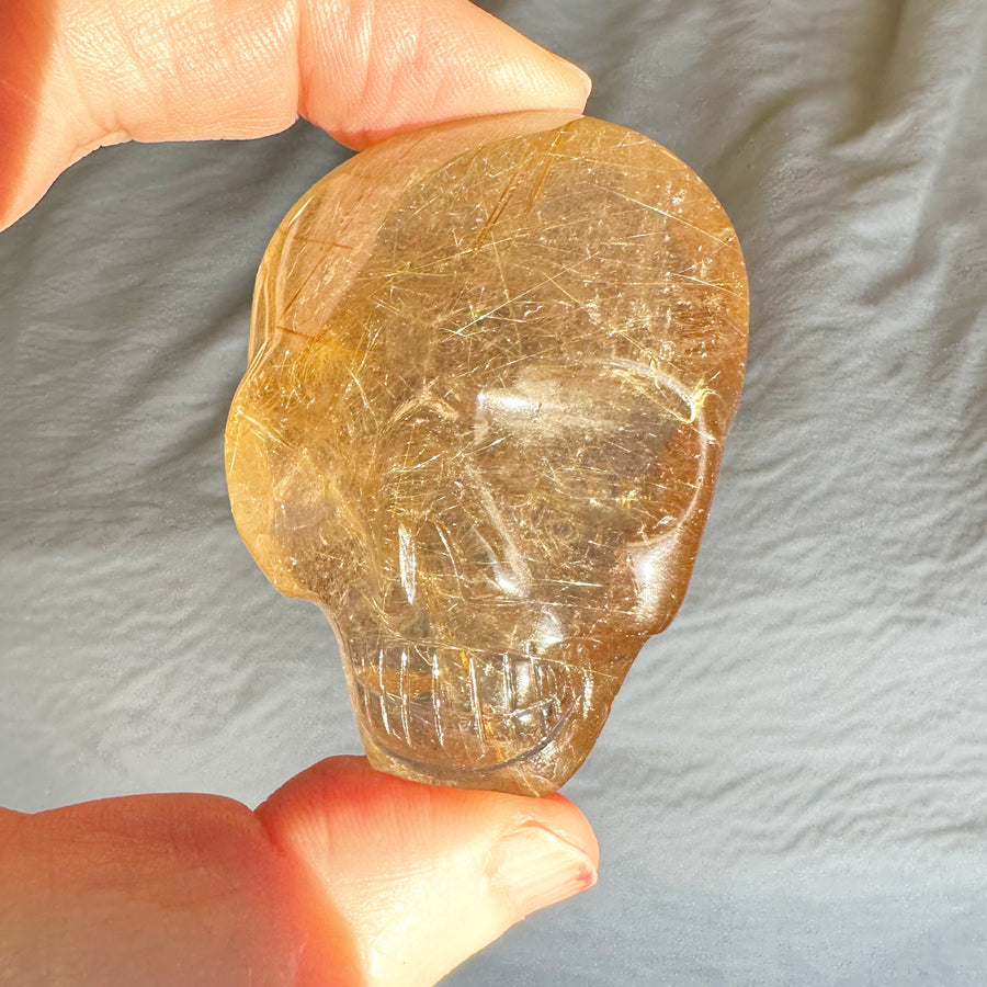 Rutile Quartz Palm Crystal Skull Carved by Leandro de Souza